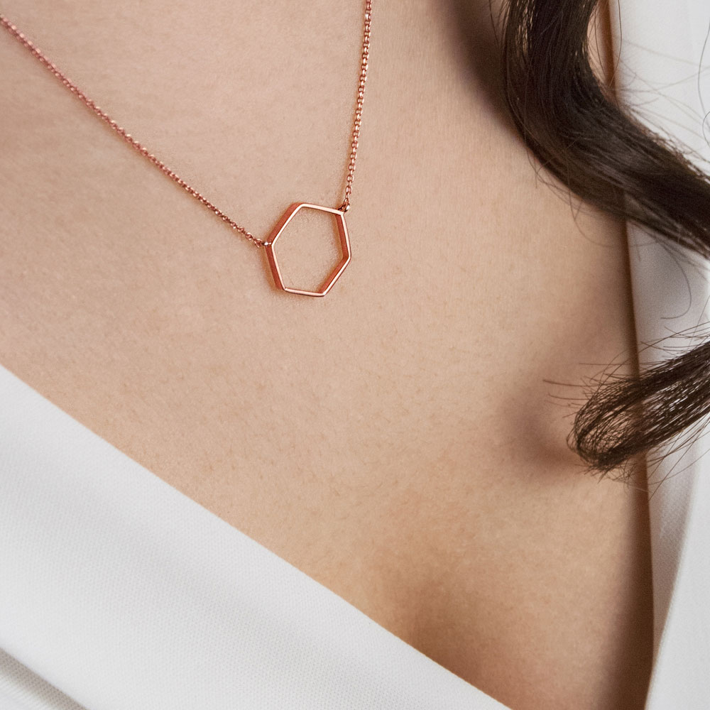 Small Hexagon Charm, Geometric Necklace in Rose Gold Worn By A Woman
