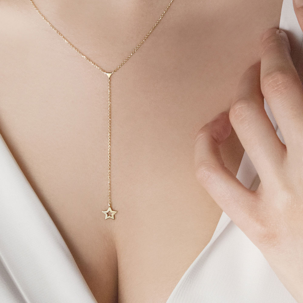 Yellow Gold Y Triangle Necklace with a Dainty Star Worn By A Woman