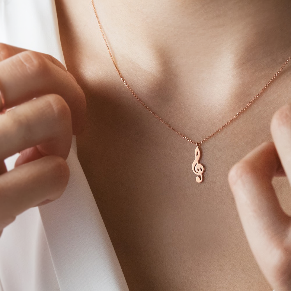 Rose Gold Treble Clef Pendant Necklace Worn By A Woman