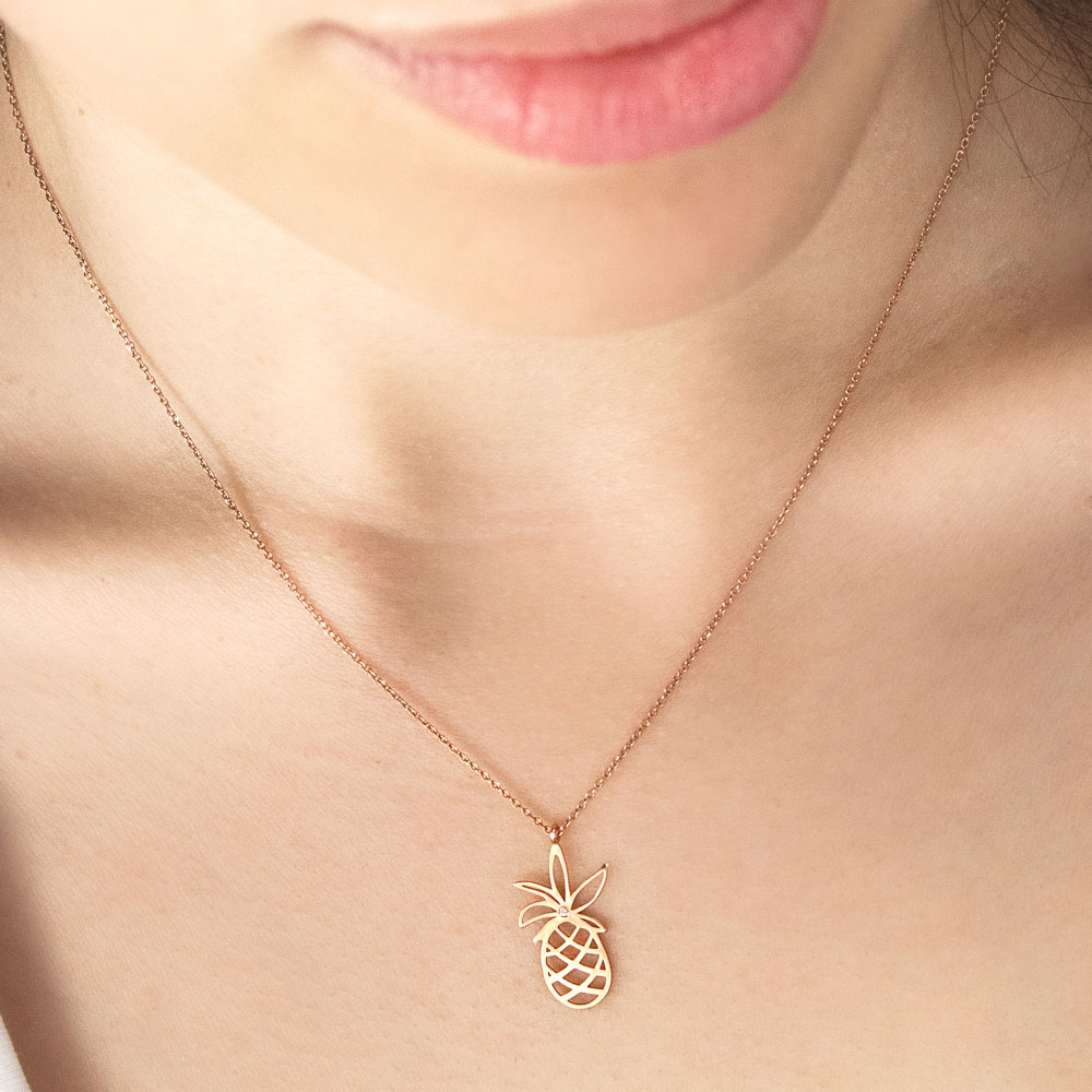 Gold Pineapple Pendant Necklace In Rose Gold a Tiny White Diamond Worn By A Woman