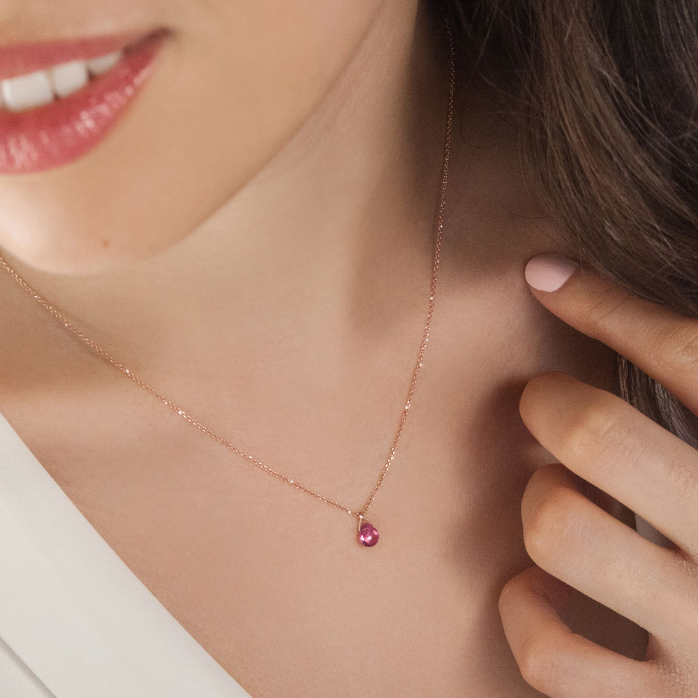 Birthstone Pendant Chain Necklace In Rose Gold with a Tiny Tourmaline Worn By A Woman