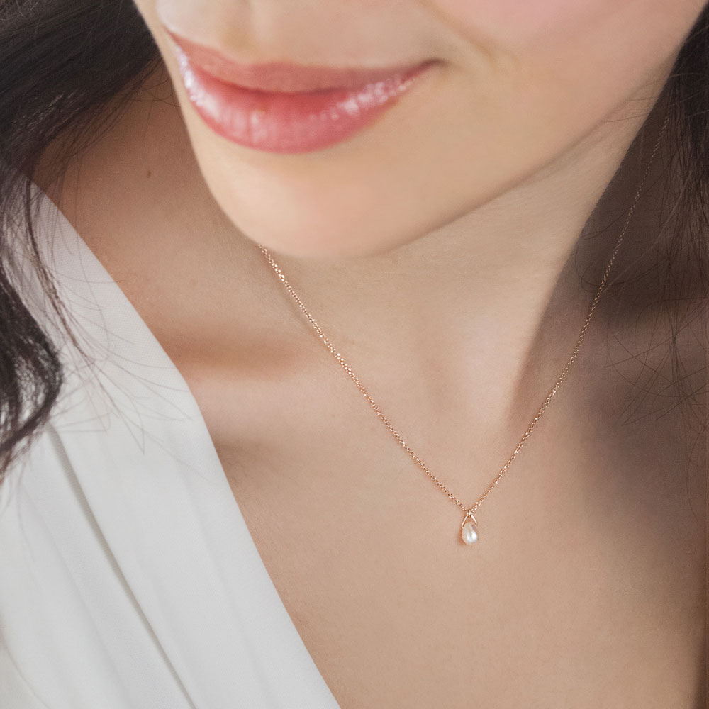 Birthstone Pendant Chain Necklace with a Tiny White Pearl Worn By A Woman