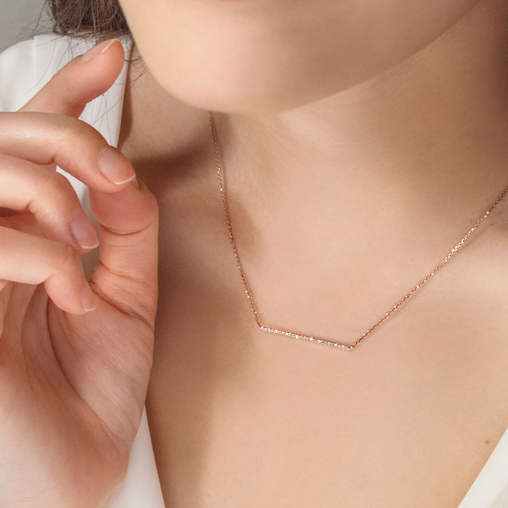 Horizontal Diamond Bar Necklace In Rose Gold Worn By A Woman