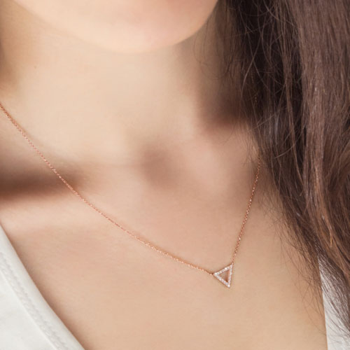 Diamond Triangle Charm Necklace In Rose Gold Worn By A Woman