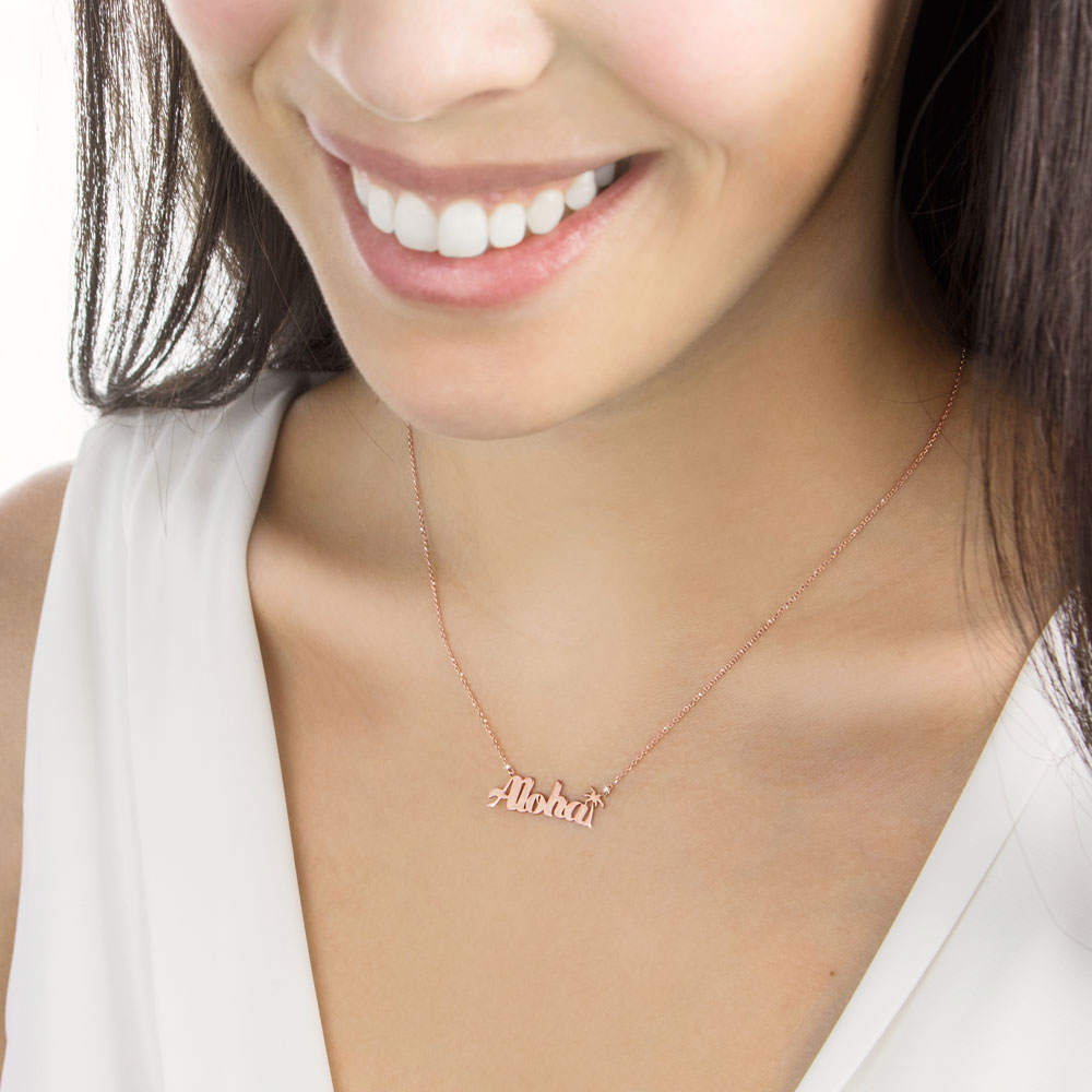 An "Aloha" Necklace In Rose Gold Worn By A Woman