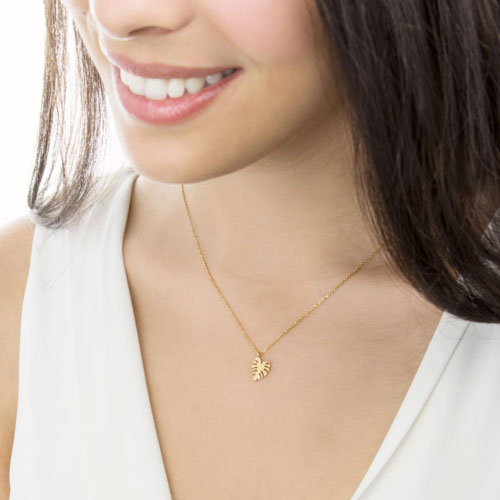 Small Monstera Leaf Pendant Necklace in Yellow Gold Worn By A Woman