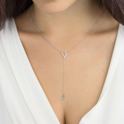 Y Necklace In White Gold with a Diamond Triangle and a Blue Topaz Worn By A Woman