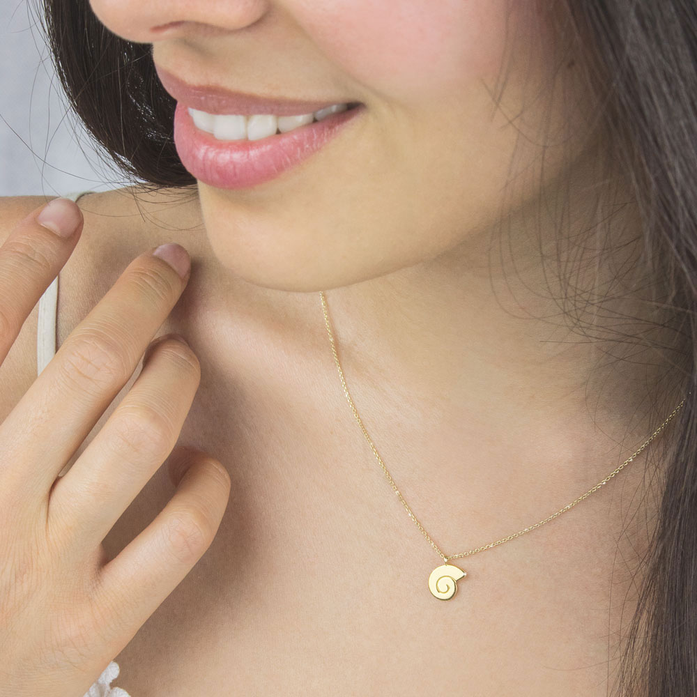 Dainty Seashell Pendant Necklace In Yellow Gold Worn By A Woman