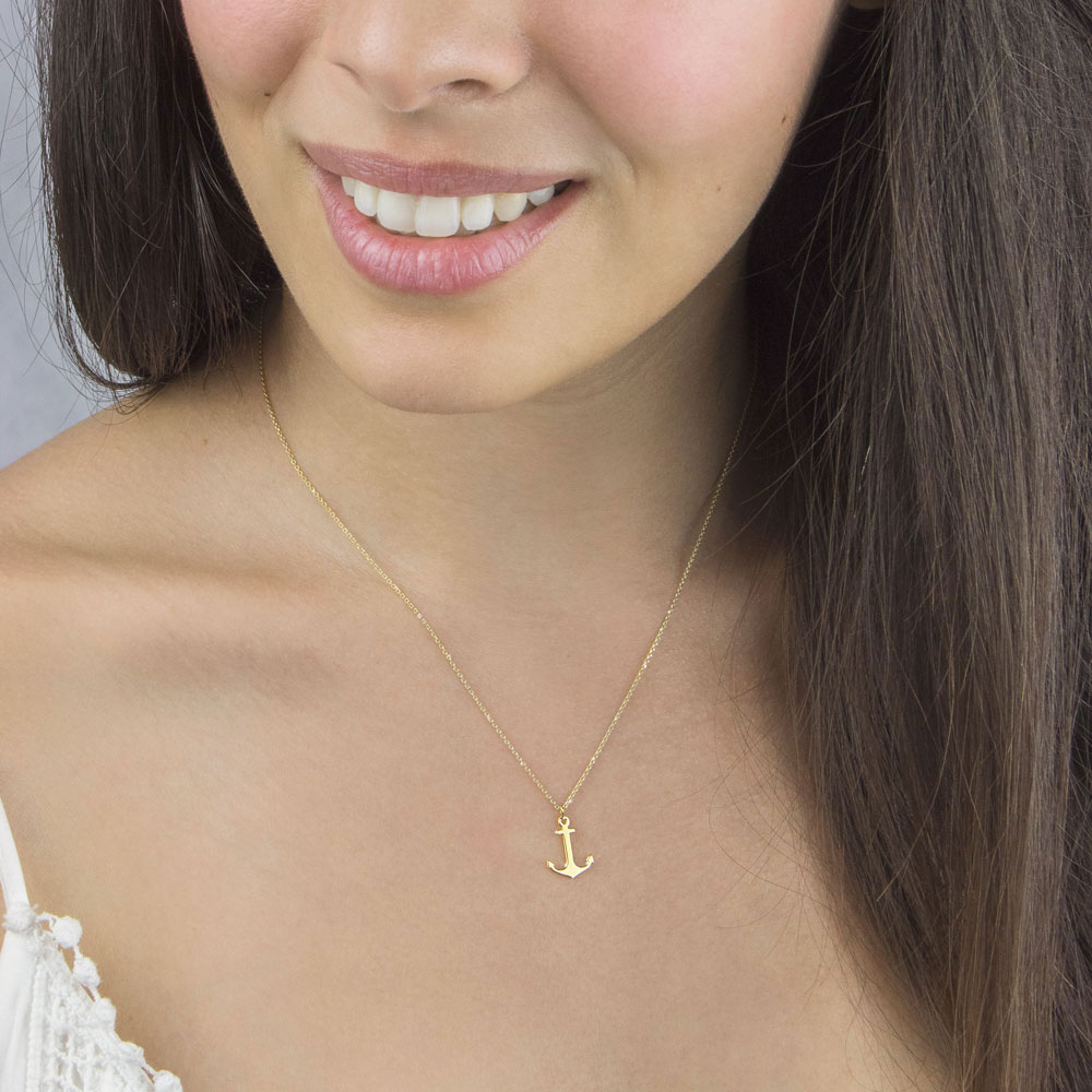 Small Anchor Pendant Necklace In Yellow Gold Worn By A Woman
