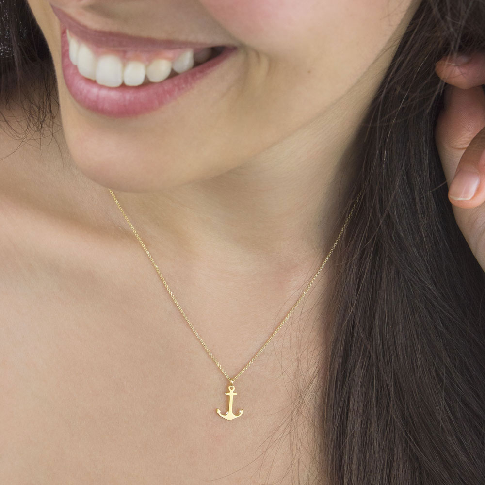 Small Anchor Pendant Necklace In Yellow Gold Worn By A Woman
