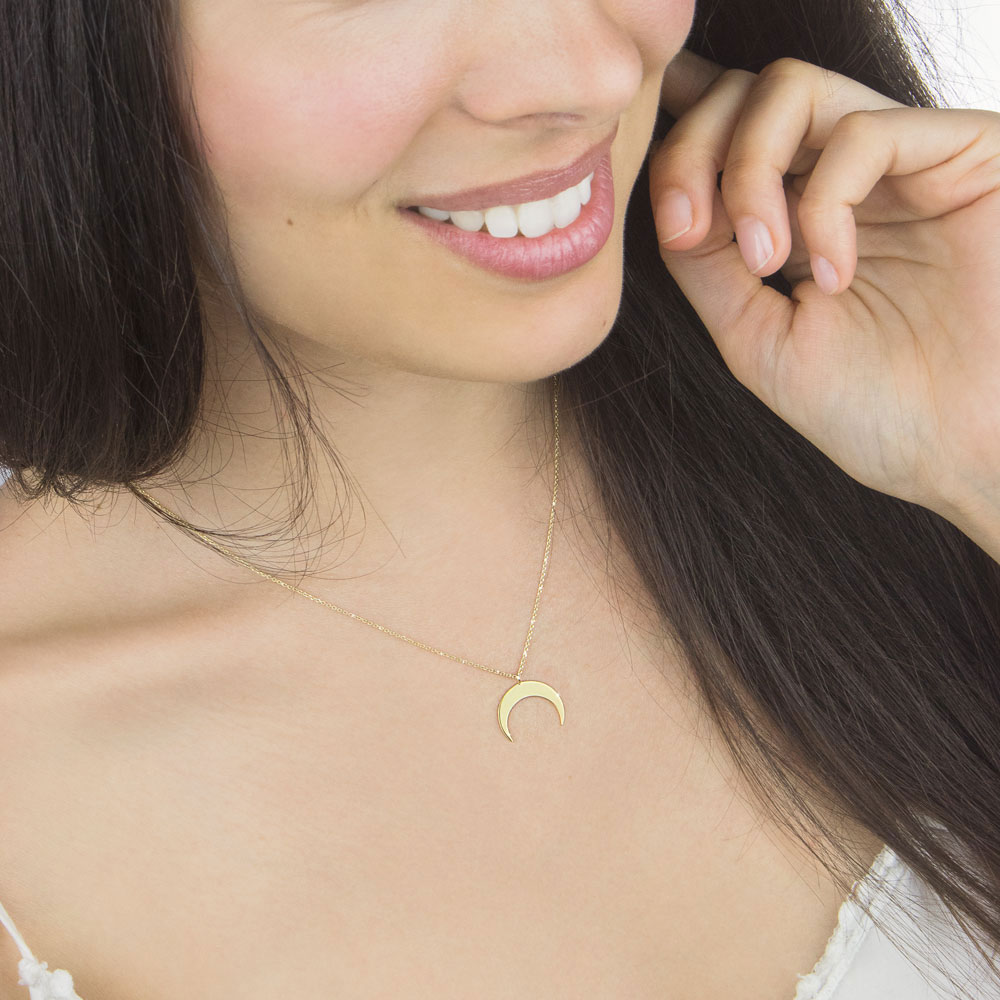 Double Horn, Crescent Moon Pendant Necklace In Yellow Gold Worn By A Woman