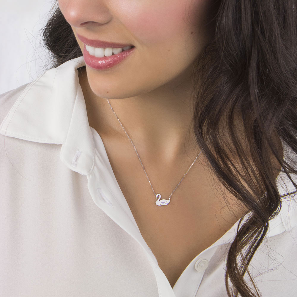 Dainty Swan Charm Necklace made of White Gold Worn By A Woman