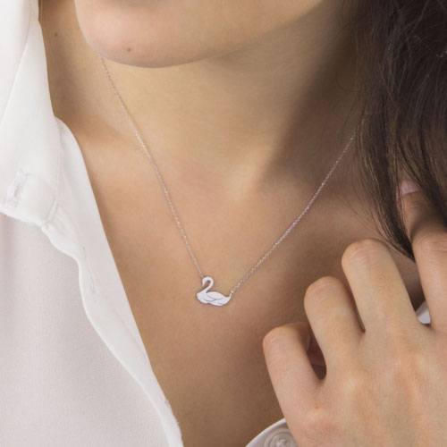 Dainty Swan Charm Necklace made of White Gold Worn By A Woman
