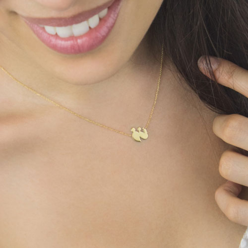 New Family Gold Charm Necklace In Yellow Gold Worn By A Woman