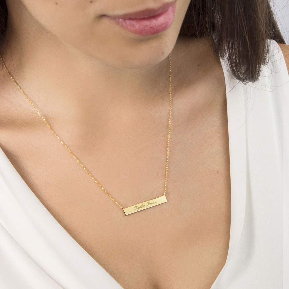 Inspirational Engraving Yellow Gold Bar Necklace Worn By A Woman