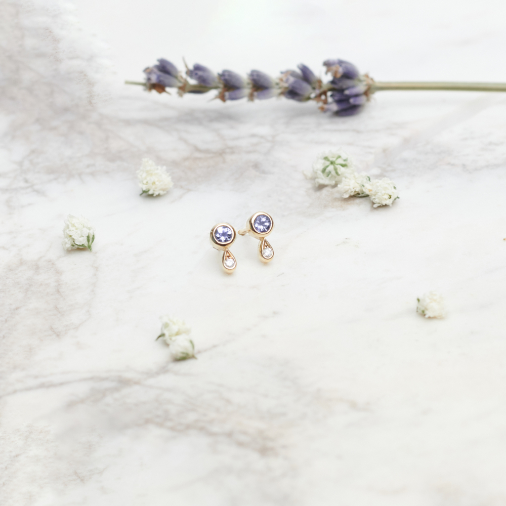 Tanzanite and Diamond Studs in Solid Gold on a white background