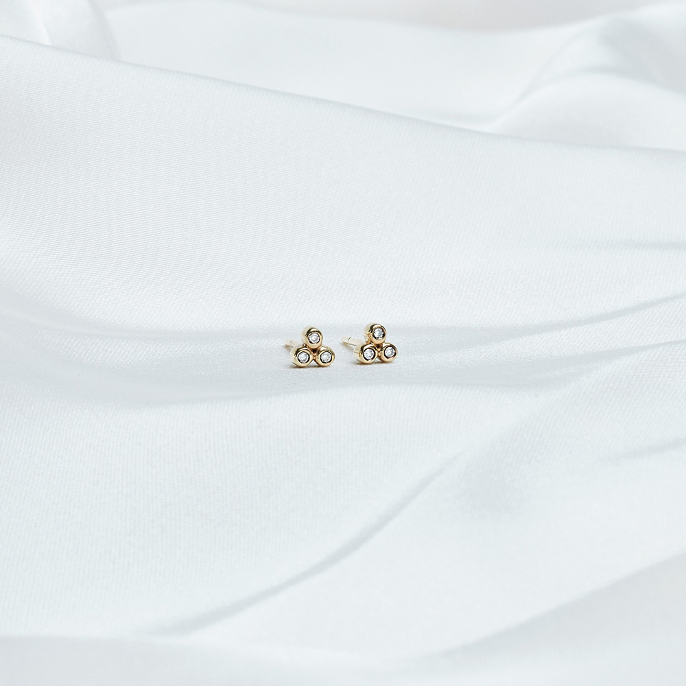 Tiny Diamond Stud earrings in Solid Gold on a white background