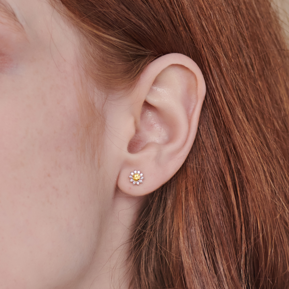 Yellow Sapphire and Diamond Earrings in Solid Gold worn by a woman