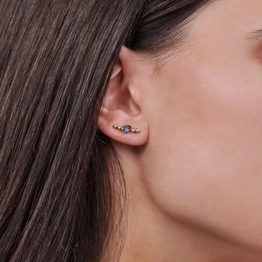 Climber Earrings with London Blue Topaz and Diamonds worn by a woman