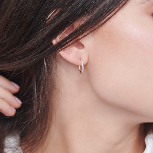 Small Diamond Hoop Earrings in Solid Gold worn by a woman