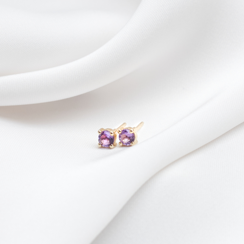 Tiny Amethyst Stud Earrings in Solid Gold with a white background