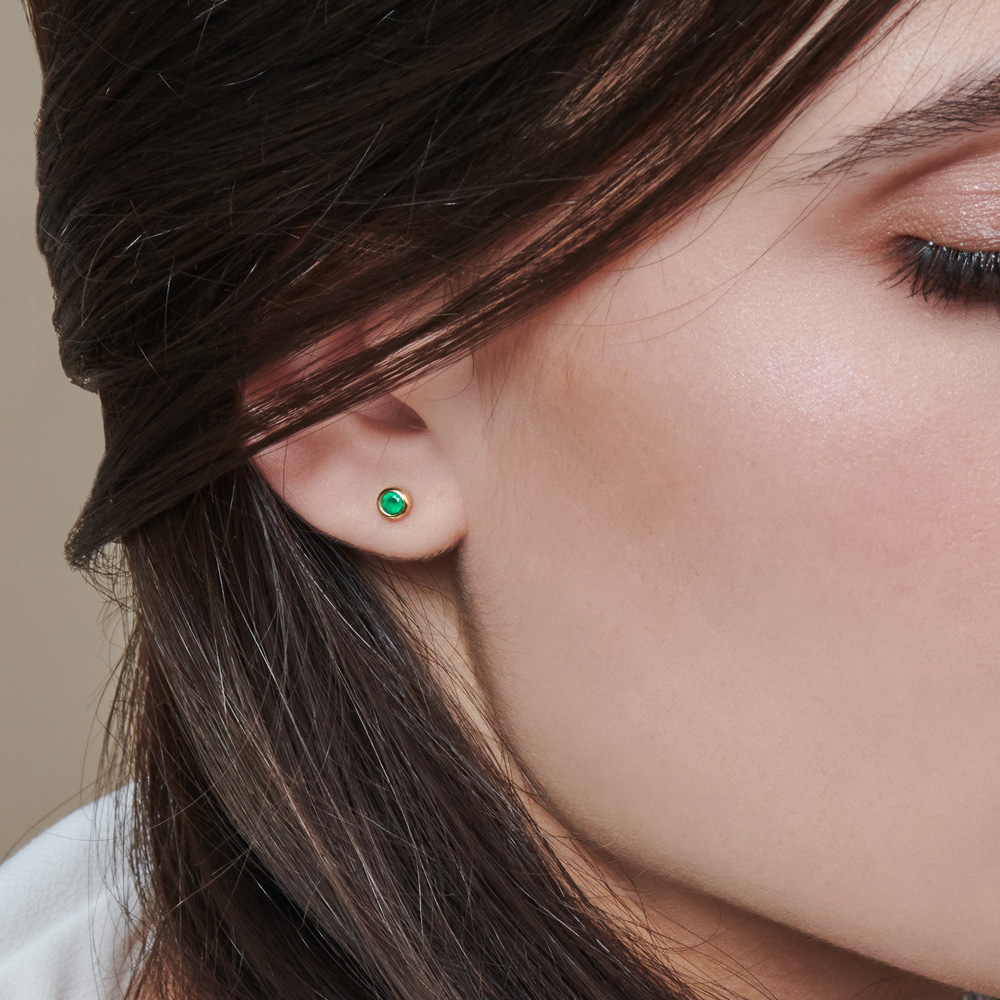 Tiny Green Agate Stud Earrings in Solid Gold worn by a woman