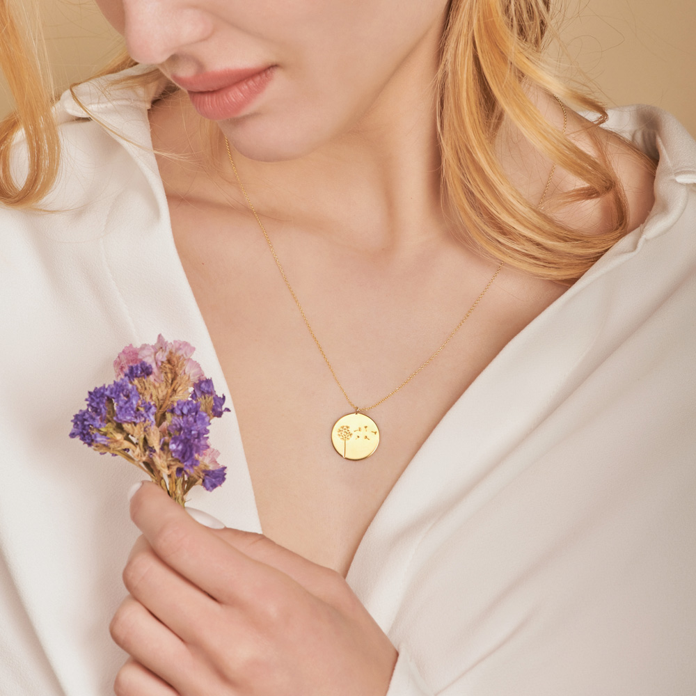 Yellow Gold Disc Pendant Necklace with an Engraved Dandelion worn by a model