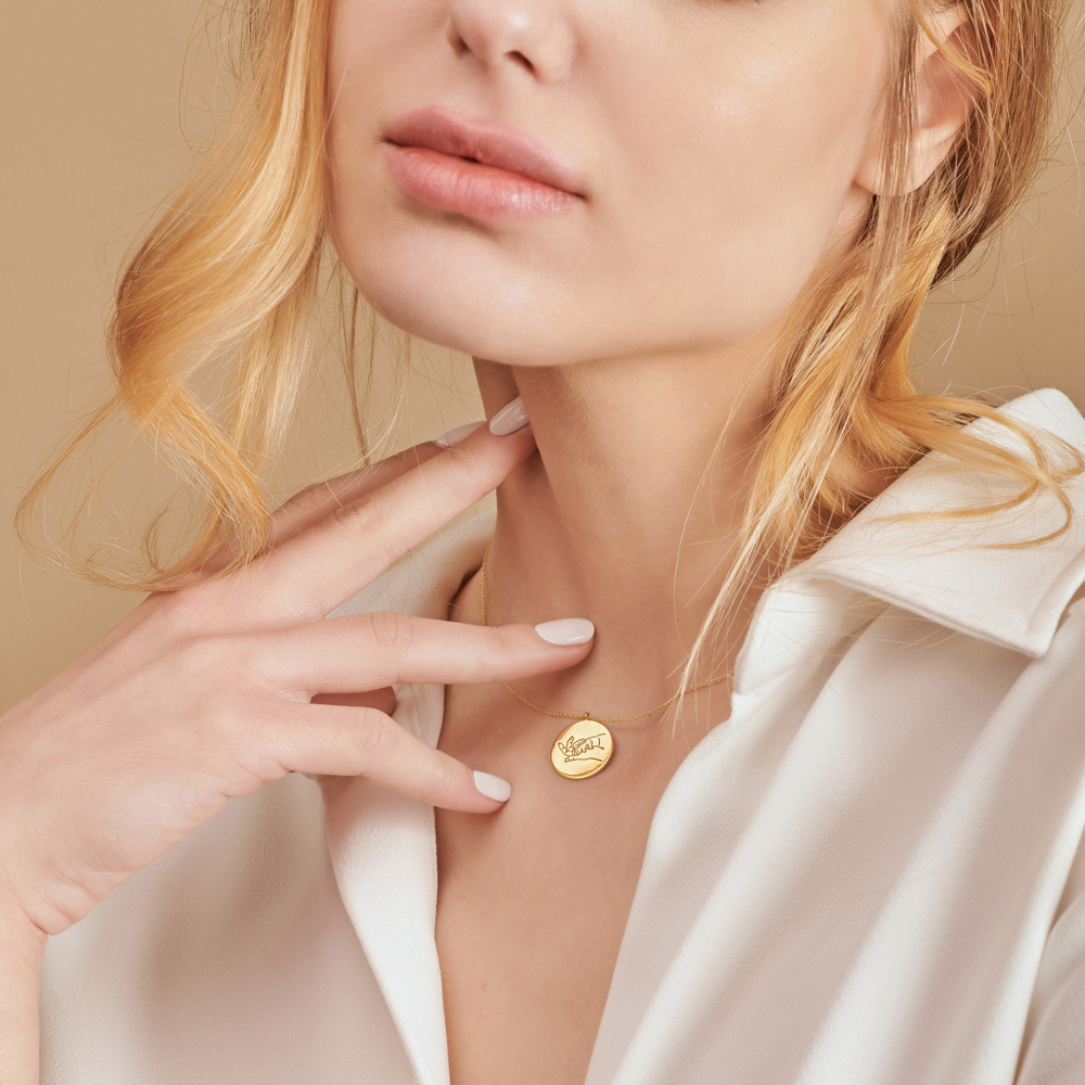 Mother and Baby Hand Gesture Necklace in Yellow Gold worn by a model